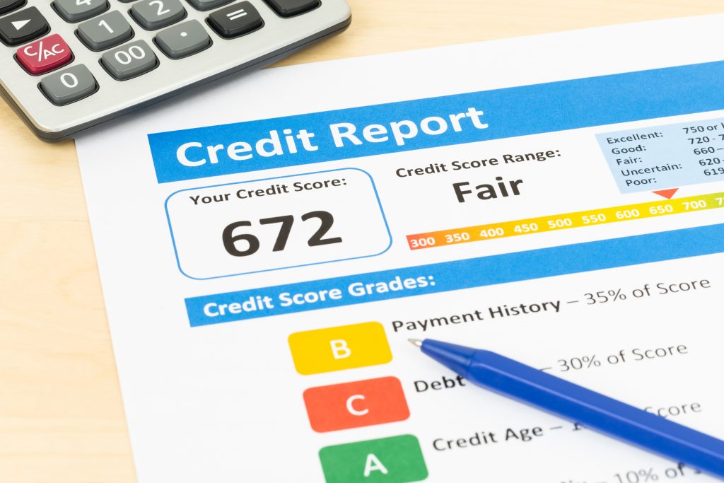 Fair credit score report with pen and calculator