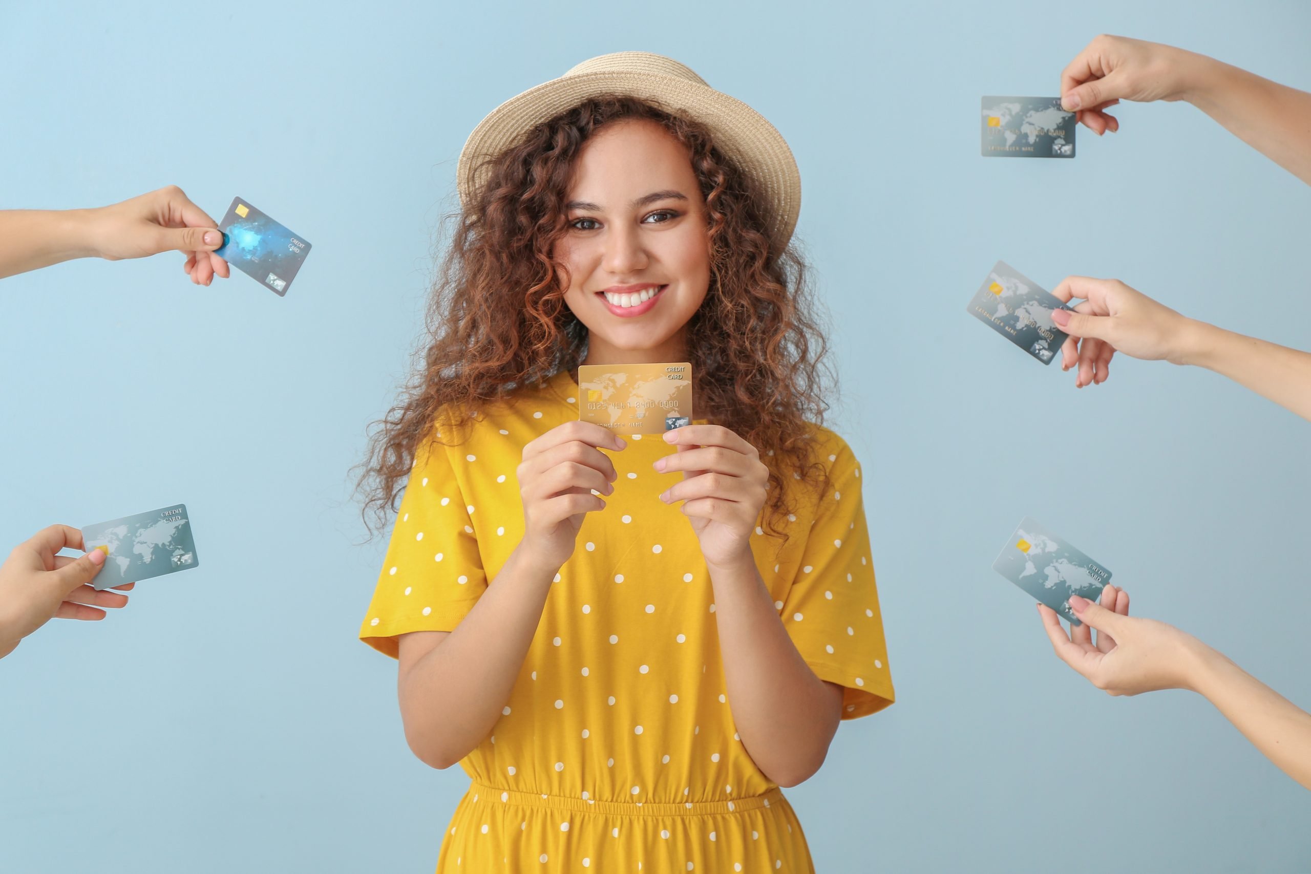 Woman and hands with credit cards on color background