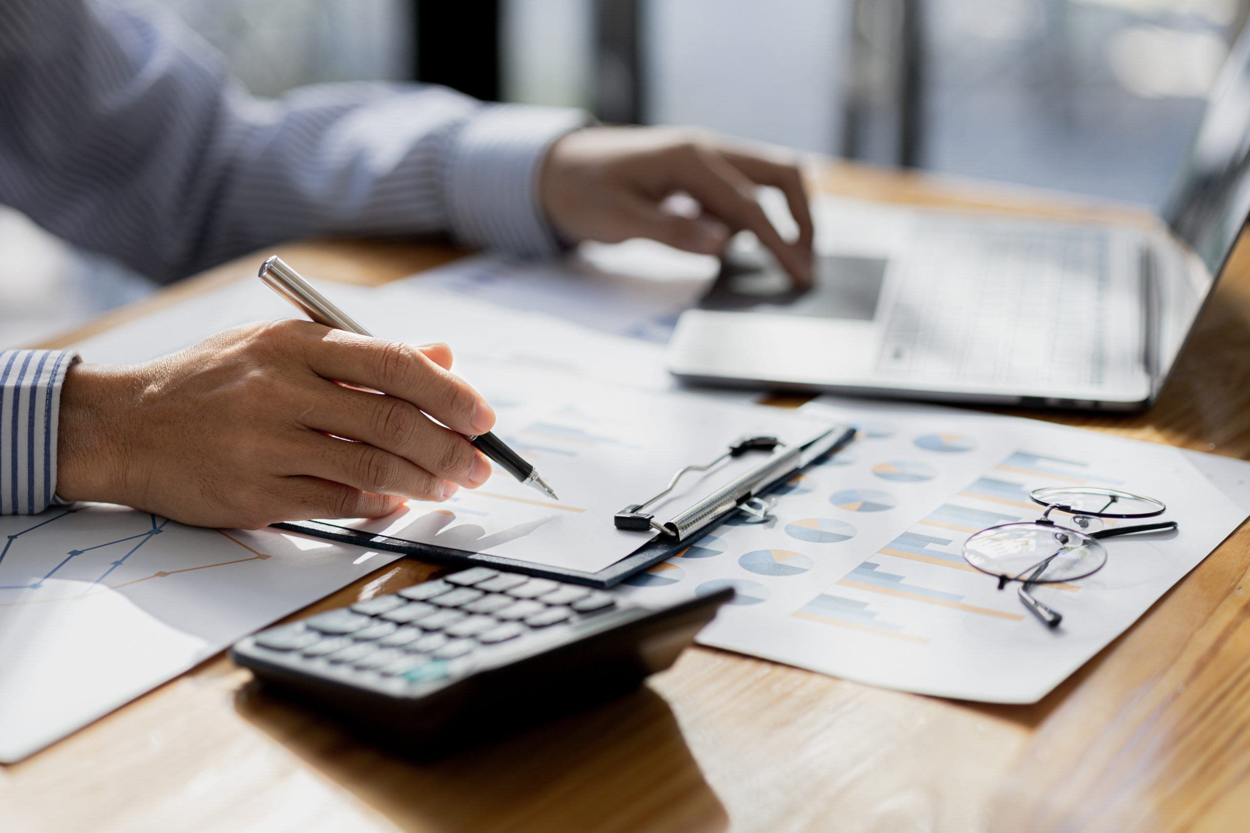 Business man pointing to a pie chart document showing company financial information