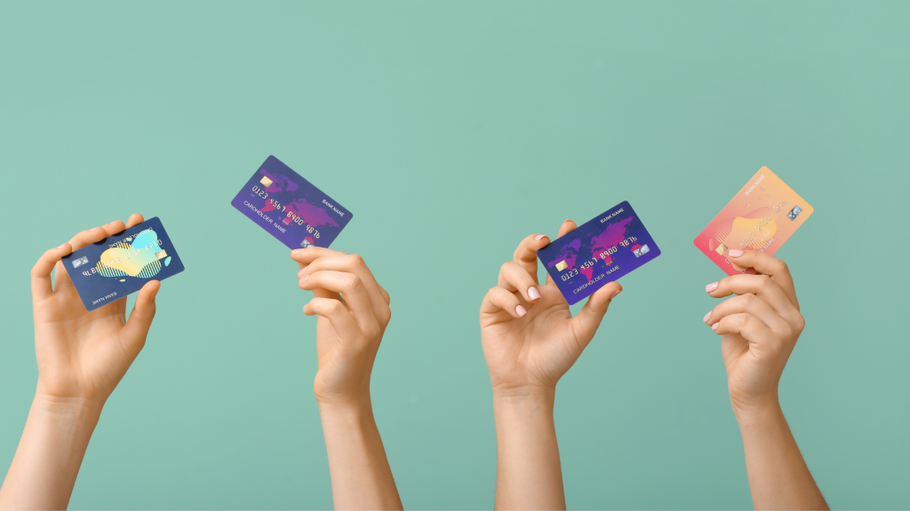 Female hands with credit cards on color background