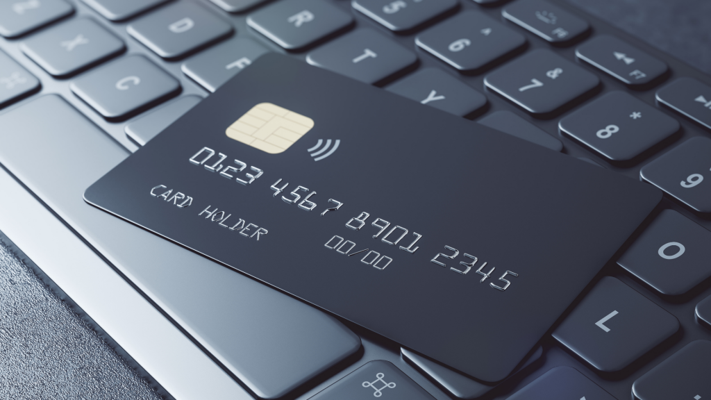 Privilege online banking concept with black credit card on dark computer keyboard (apply Upgrade Bitcoin Rewards Card).