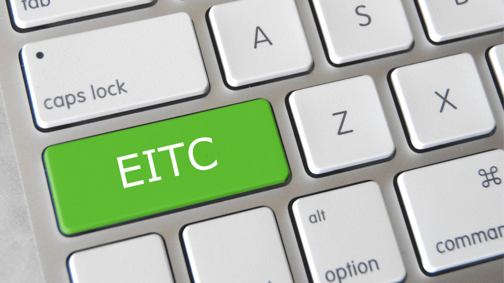 Computer keyboard with green button that says "EITC"