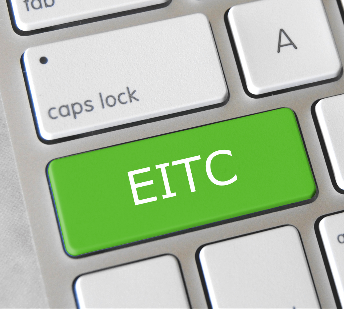 Computer keyboard with green button that says "EITC"