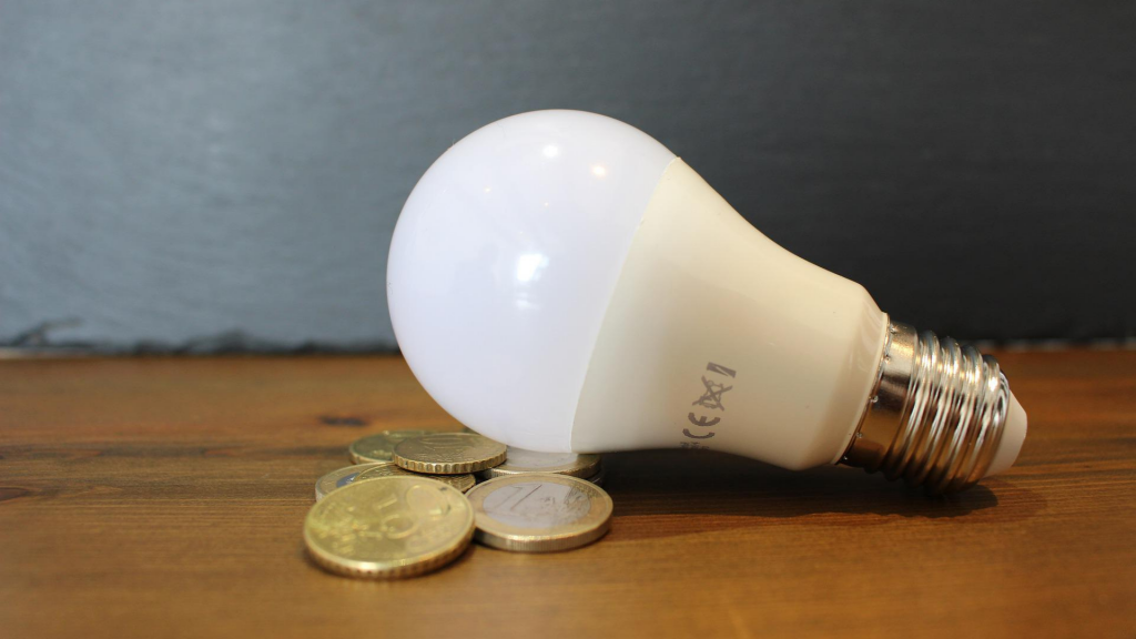 lamp on the table along with coins and money bills.