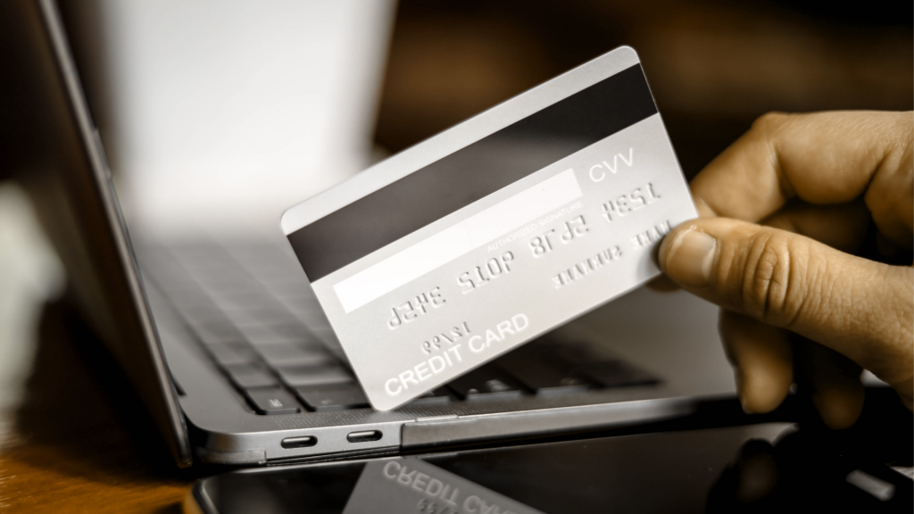 The person holds a silver credit card and is filling out their credit card information to pay for goods online, credit cards can pay for goods and services both in the storefront and online shopping. (Apply Mercury® Mastercard® card)