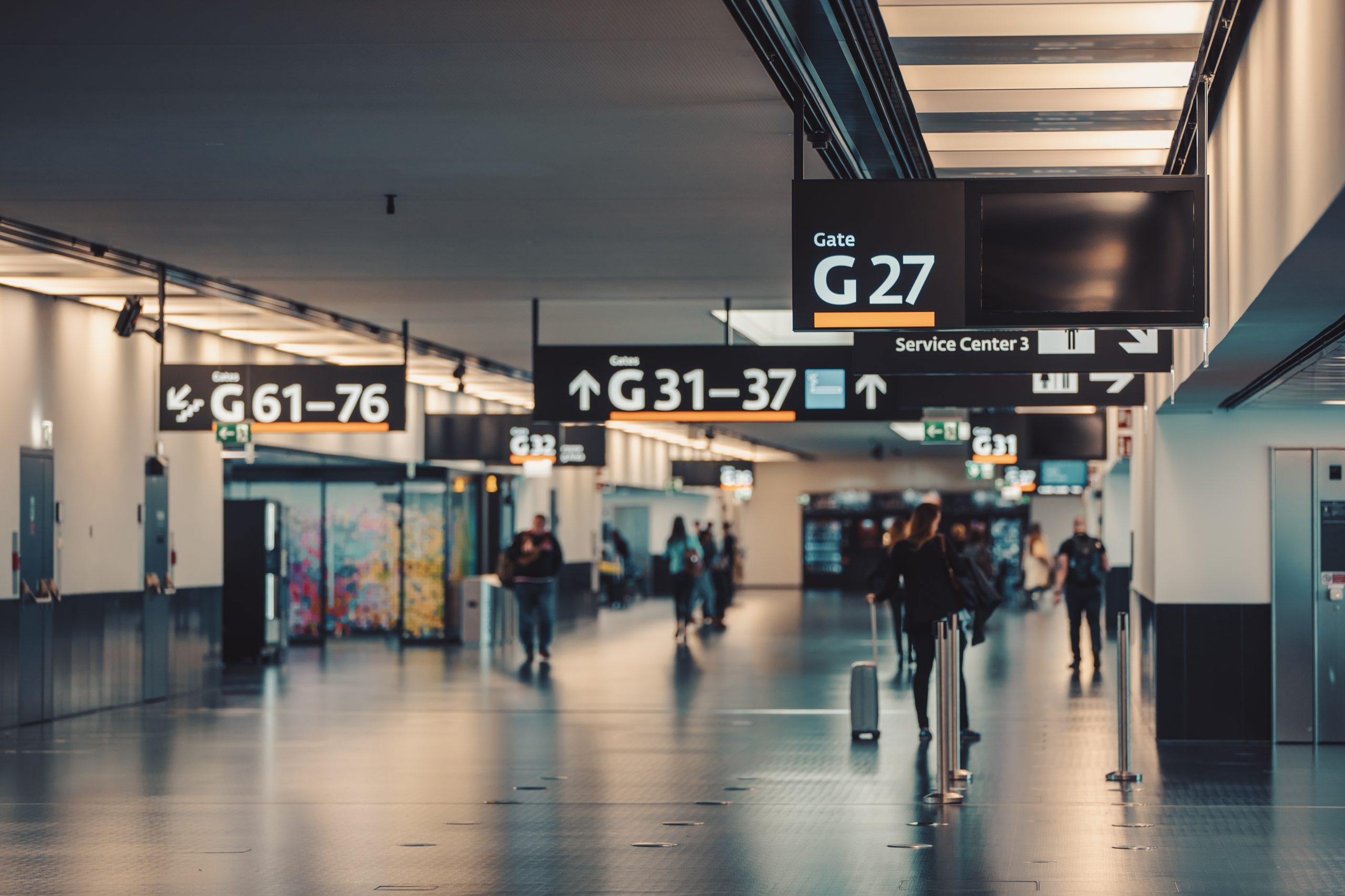 Peoples walking and carries luggage in Vienna airport terminal