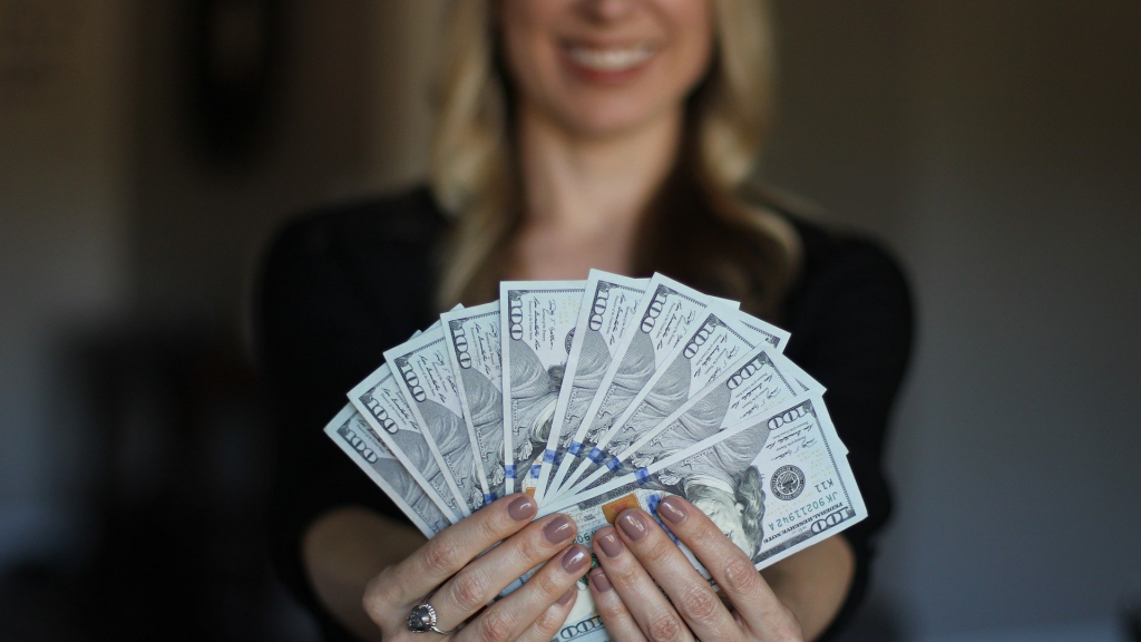 woman holding big amount of money.