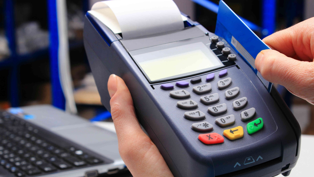 Blue credit card being inserted into a card machine