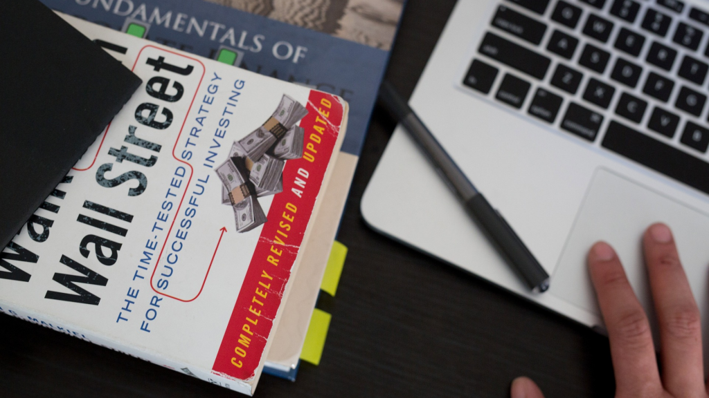 Stack of investment books and notebooks