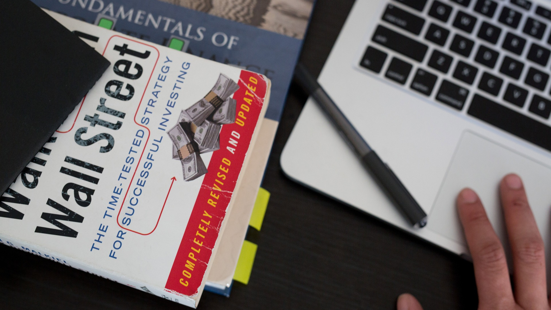 Stack of investment books and notebooks