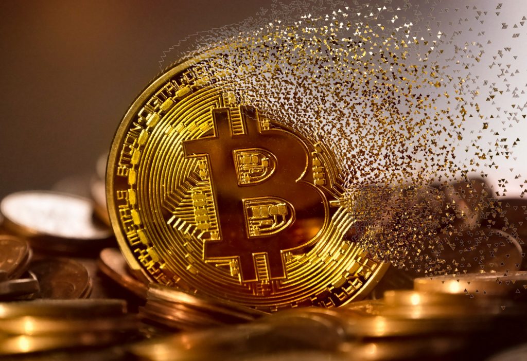 golden bitcoin coin falling apart in midair