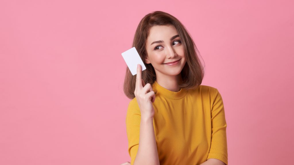 Woman holding white credit card