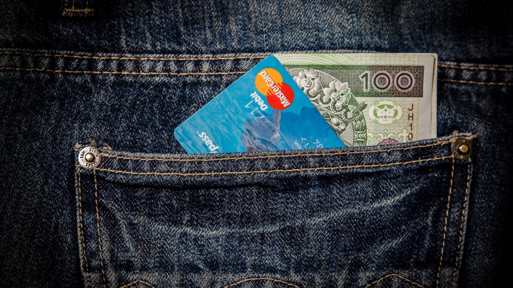 Pocket with credit card and money bills (apply First Progress Platinum Prestige Mastercard® Secured card)