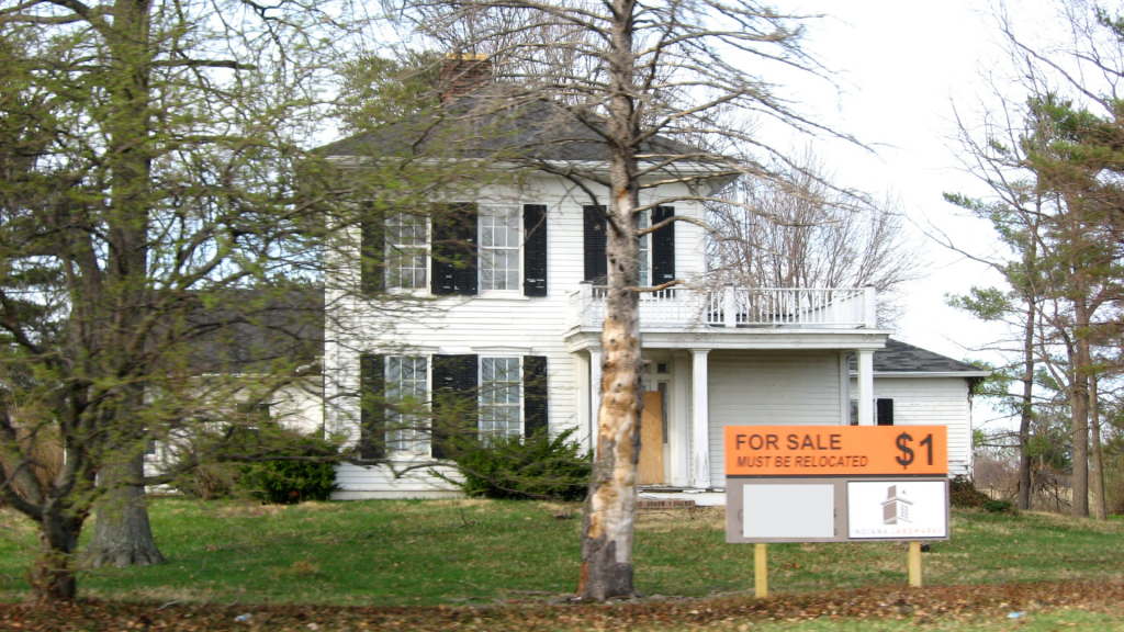 House/home with for sale sign indicating the value of $1