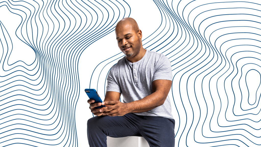 Black man using a smartphone (apply Avant personal loan)