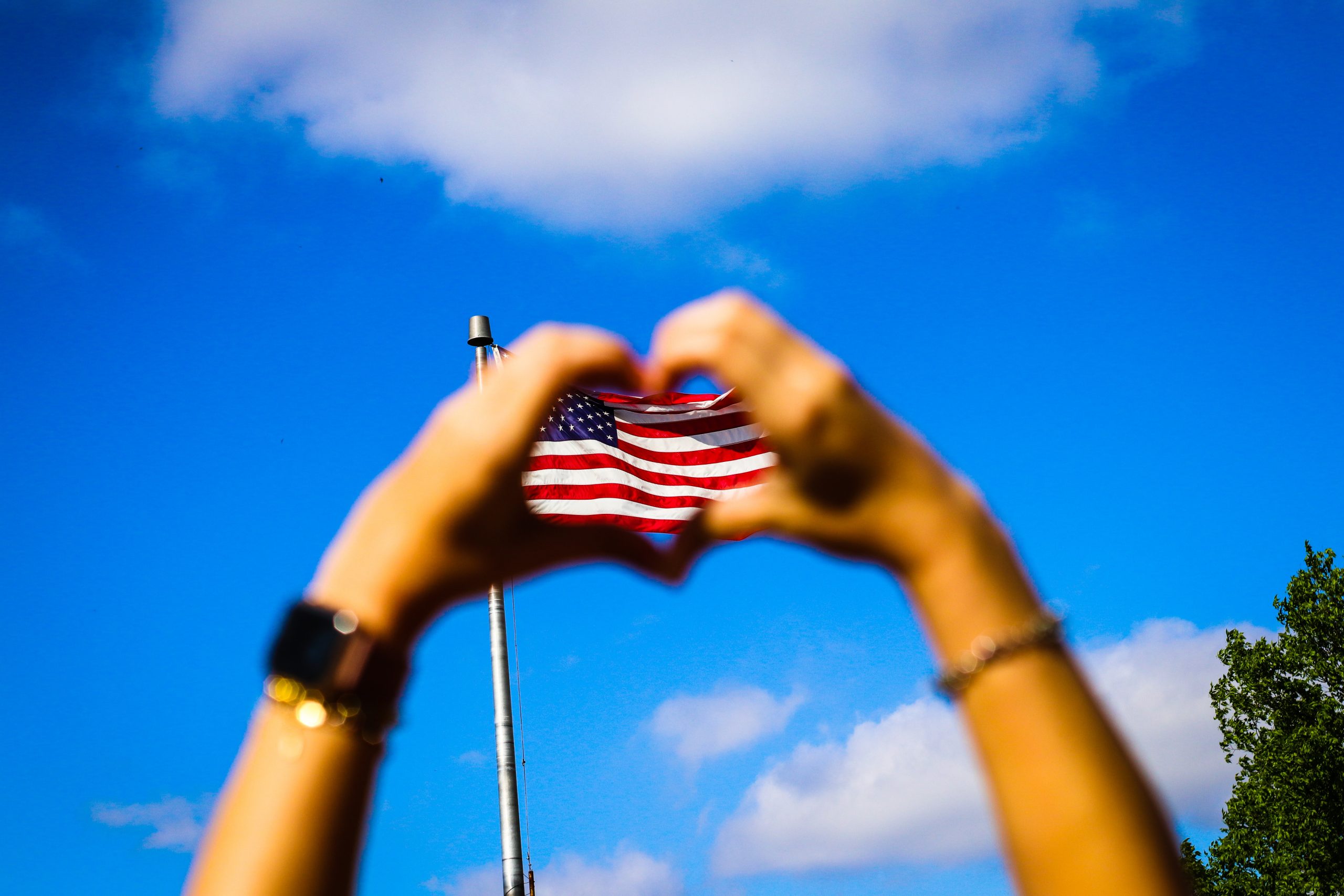 Hands making heart on Unites States flag