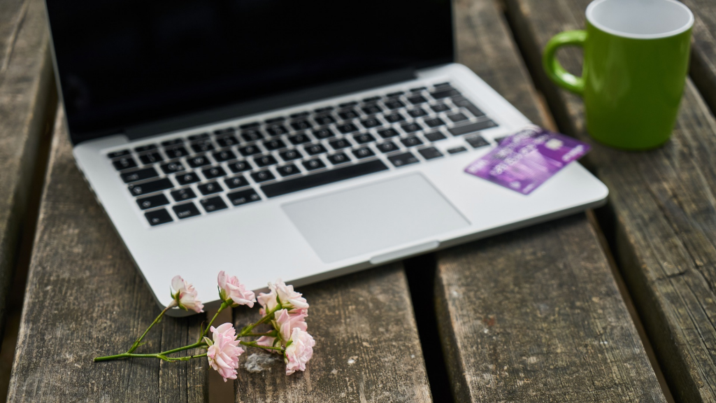 violet credit card over notebook/laptop