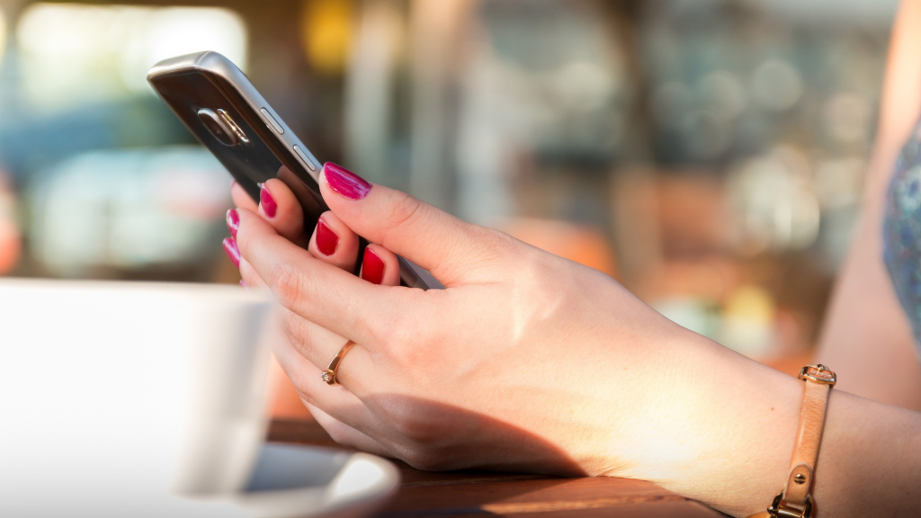 woman using cell phone/smartphone (apply Citi Simplicity® Card)