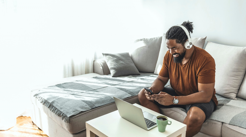 black man using cellphone (apply NedBank Gold Credit Card)