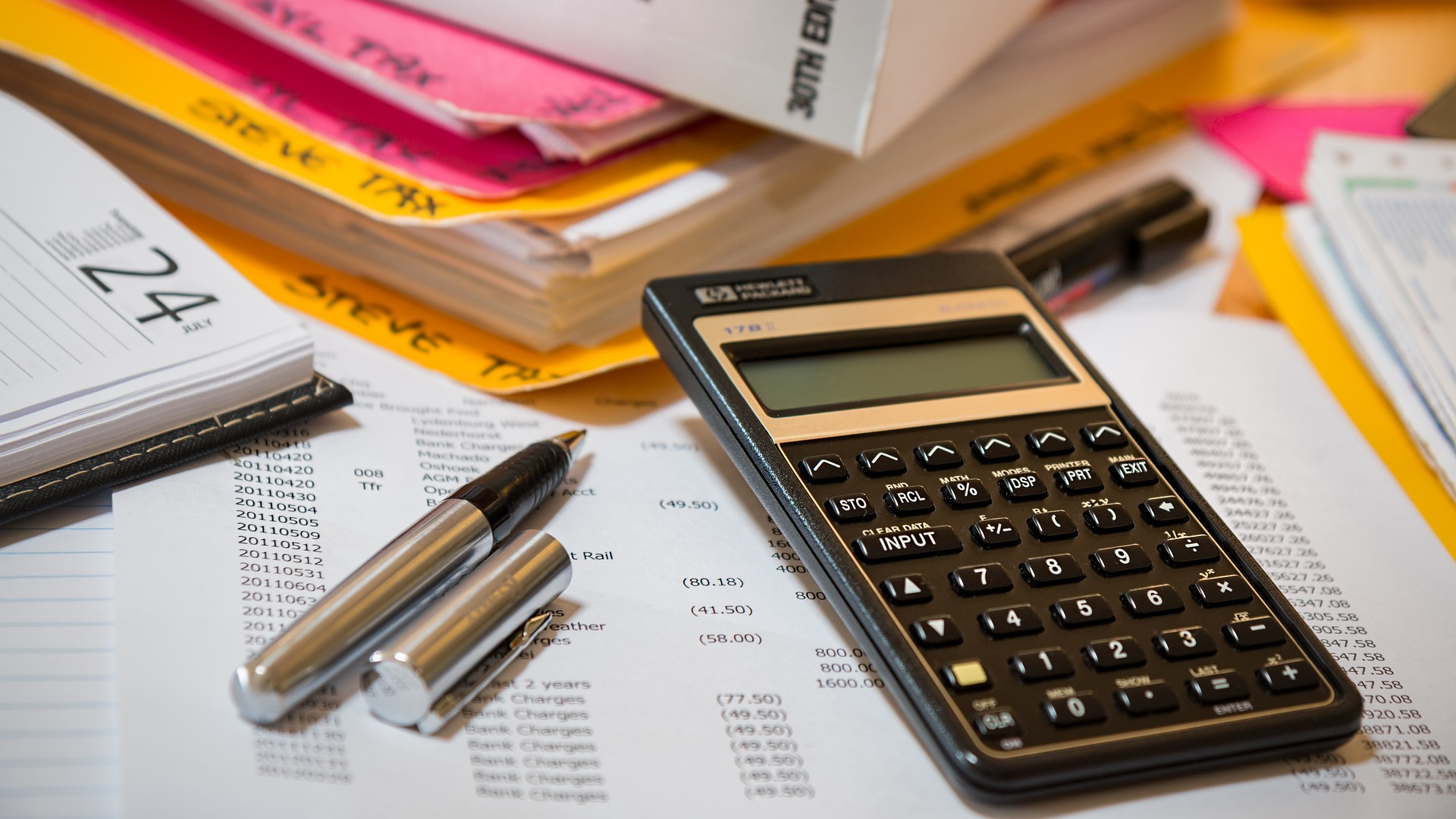 Calculating budget: calculator, pen and sheet