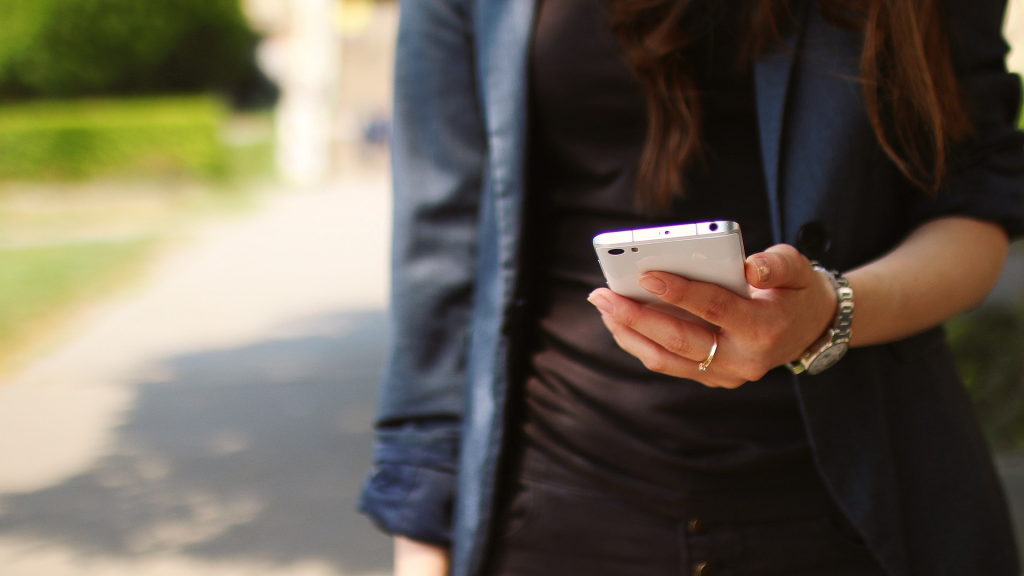 woman with a smartphone in her hand (apply TymeBank Credit Card)