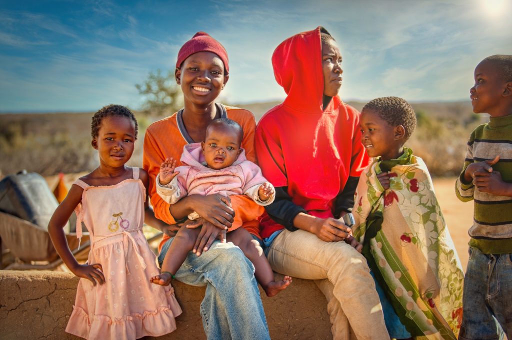 African family group of kids and teenagers, village in Botswana