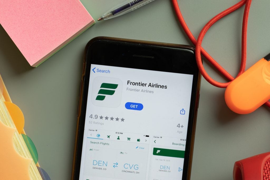 New York, USA - 27 September 2020: Frontier Airlines mobile app logo on phone screen close up, Illustrative Editorial