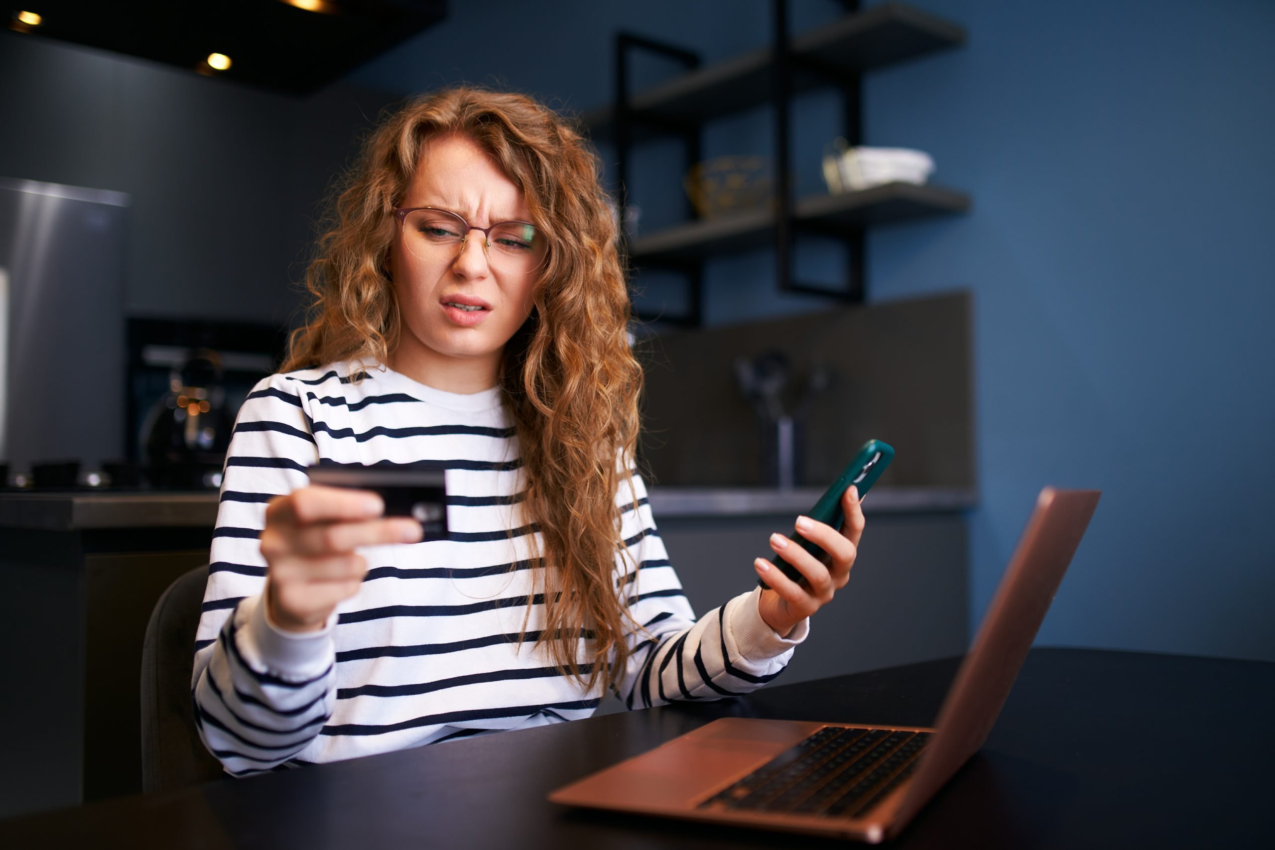 Worried woman with smartphone, debit card has problem paying bill, forgot banking app password. Female can't pay due to insufficient funds, sanctions, unsecure transfer. Unsuccessful transaction.