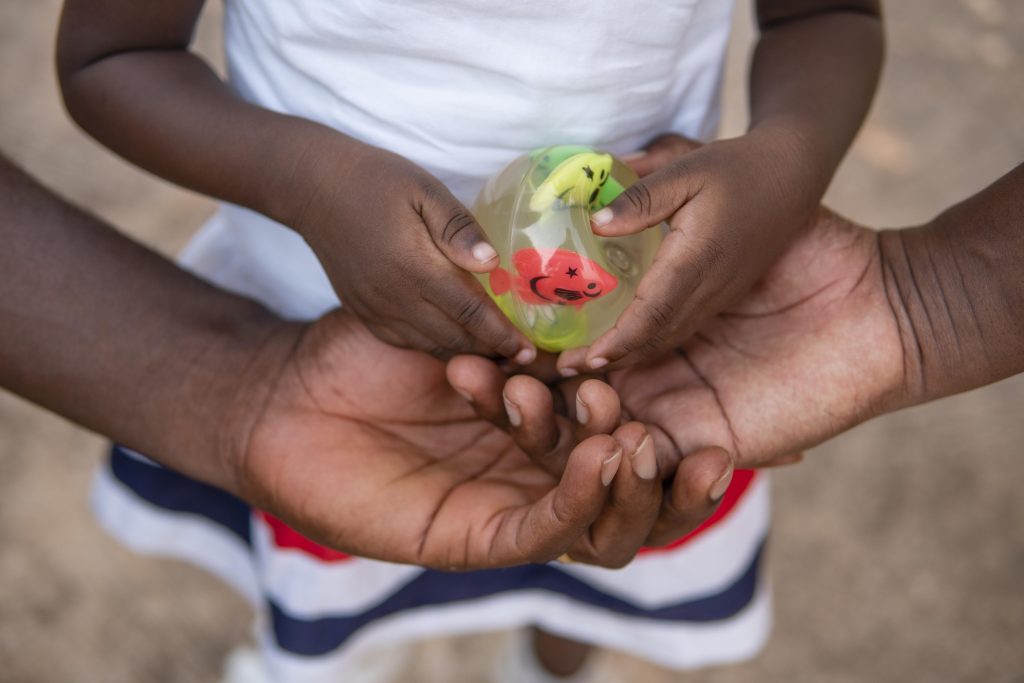 cute-little-black-girl-holding-toy-with-fish