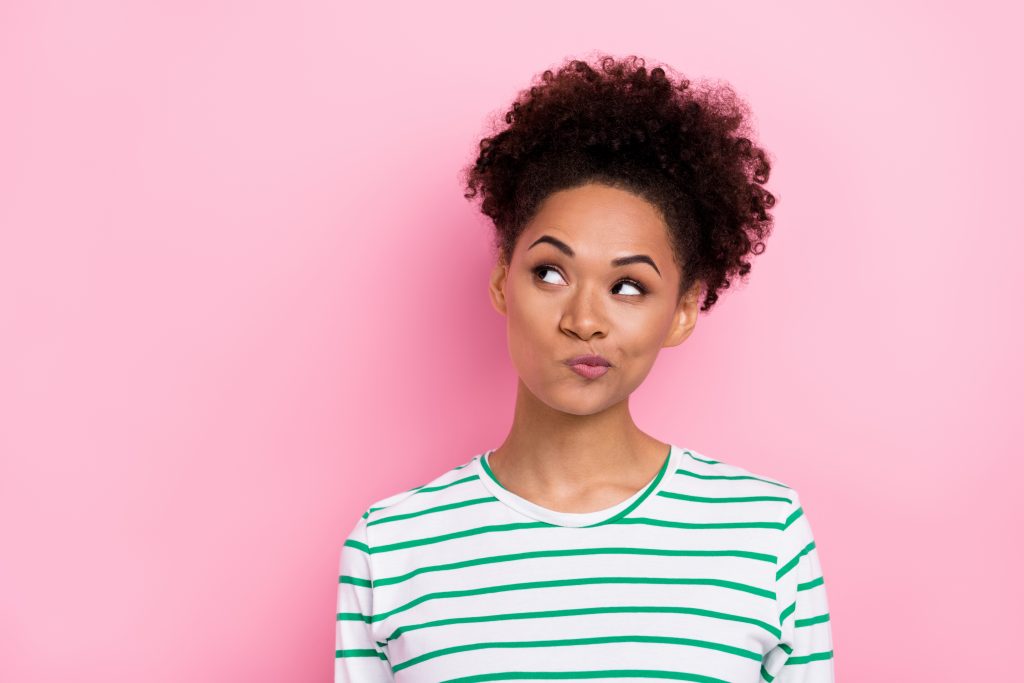 Photo of unsure wavy millennial lady look promo wear striped shirt isolated on pink color background