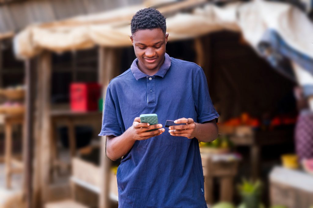 young man selling and purchasing online using mobile phone