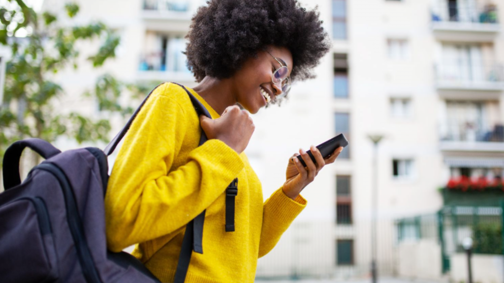Young woman smiling using a smartphone