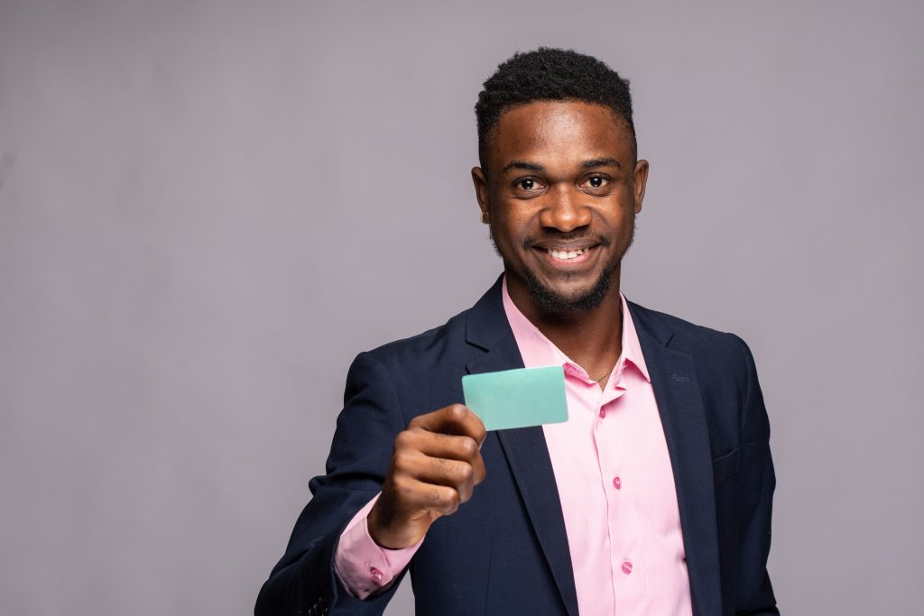 a black man holding a card