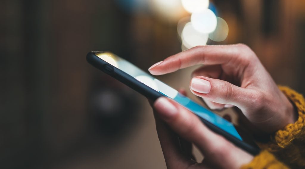 point finger on screen phone closeup, person texting text messag