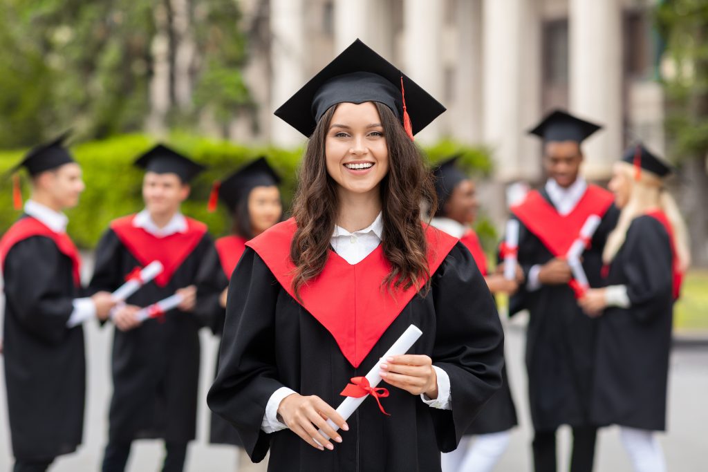 Cheerful young woman student having graduation party