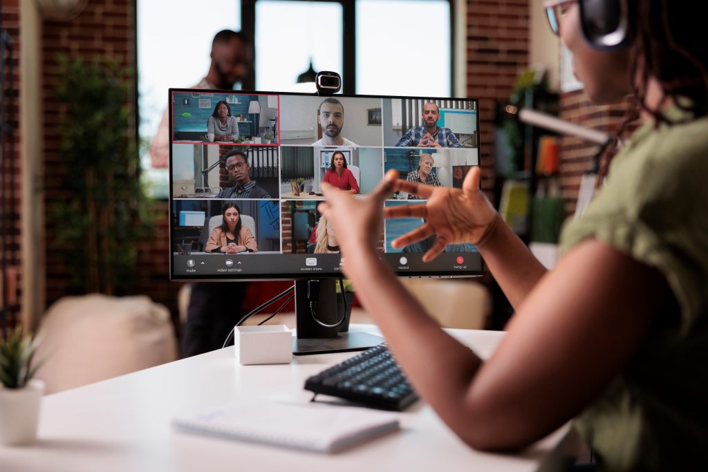 African american startup employee working from home gesturing in video conference with colleagues